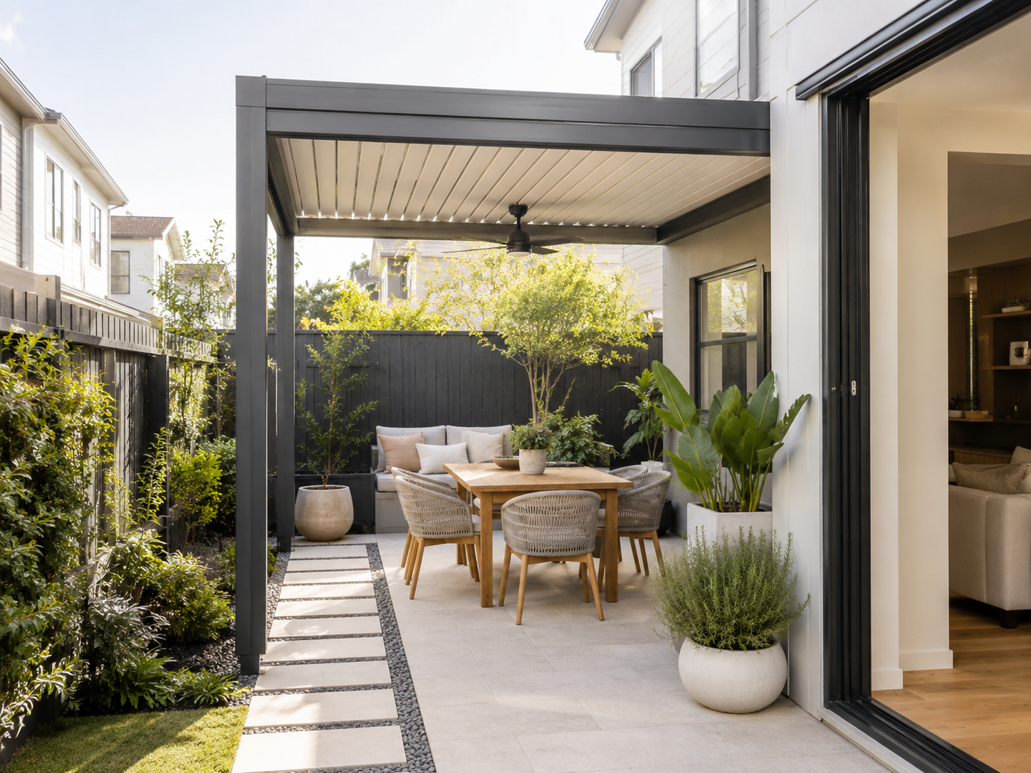 Covered patio with dining area and clear walkway in a compact backyard