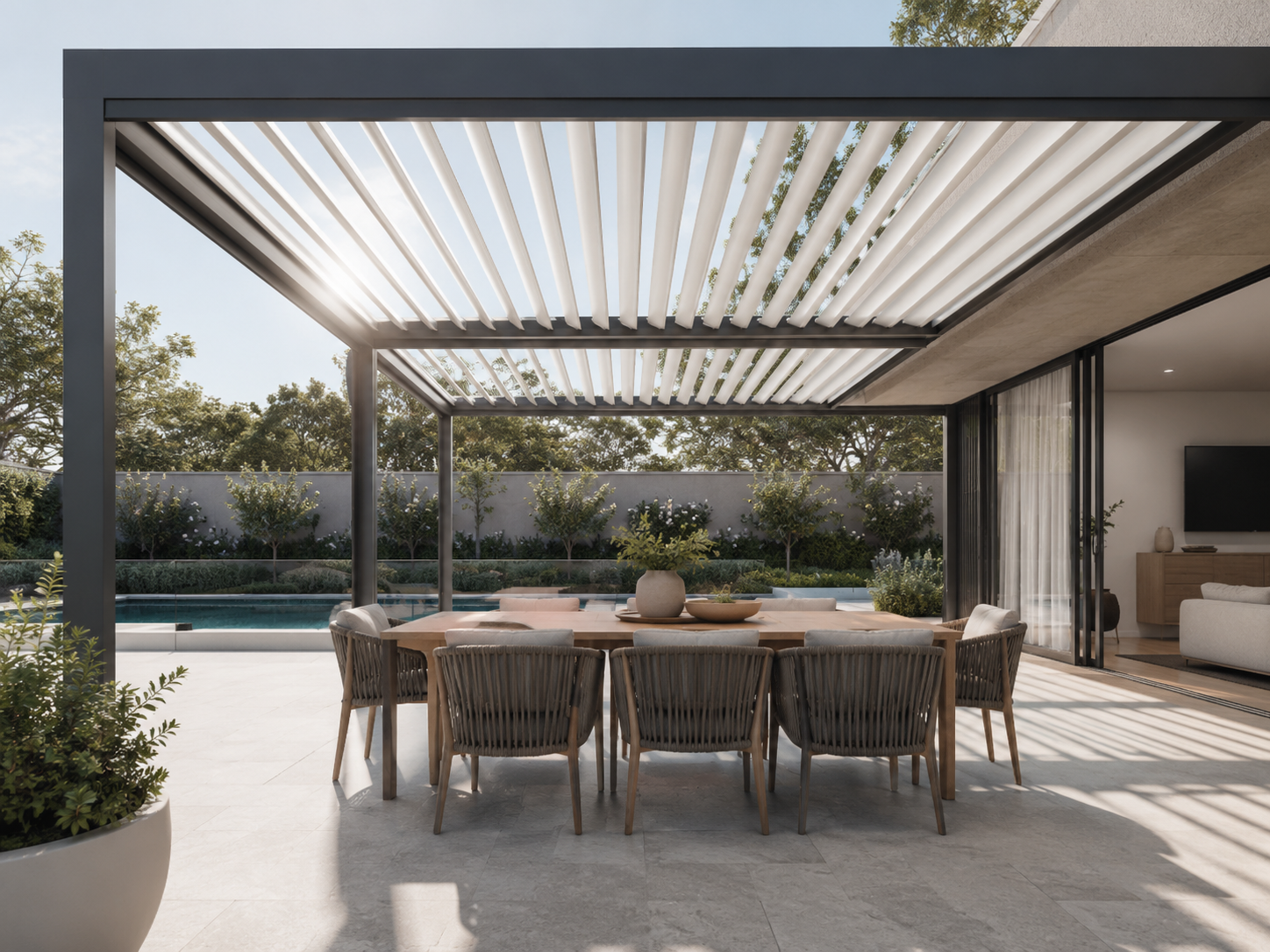Bioclimatic pergola with adjustable louvres over an outdoor dining patio at an Australian home